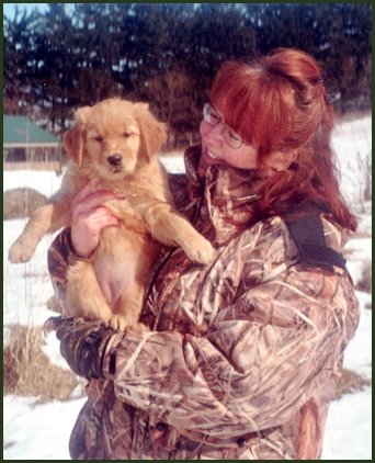 photo of golden retriever pup with owner